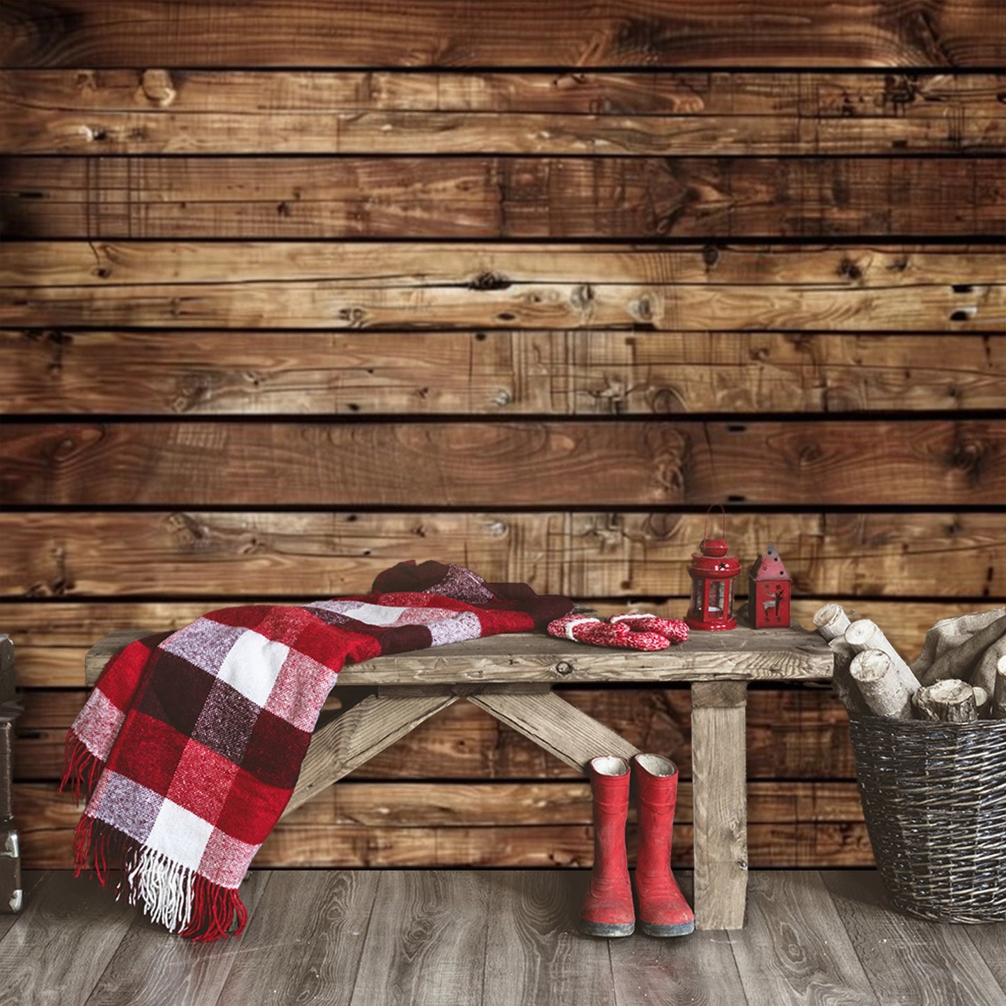 Rustic wooden bench with a red and white checkered blanket, red gloves, red boots, two red lanterns, and a basket of firewood set against the Wooden Boards Photography Wood Backdrop-ideasbackdrop by ideasbackdrop that evokes a nostalgic atmosphere.