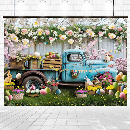 A rustic blue pickup truck decorated with Easter-themed items, including eggs, flowers, and rabbits, is set against a white picket fence adorned with floral garlands—an ideal Blue Truck Colorful Eggs Rabbit Floral Backdrop-ideasbackdrop by ideasbackdrop for photographers and event planners.