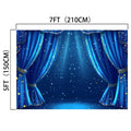 A stage backdrop featuring blue curtains adorned with gold stars and measuring 7 feet (210 cm) in width and 5 feet (150 cm) in height. This theater wall backdrop, the ideasbackdrop 7x5ft Blue Curtain Stage Backdrop Photography Theater Stage Spotlight Background Photo Studio Props, boasts wrinkle resistance and is illuminated with a blue spotlight effect.