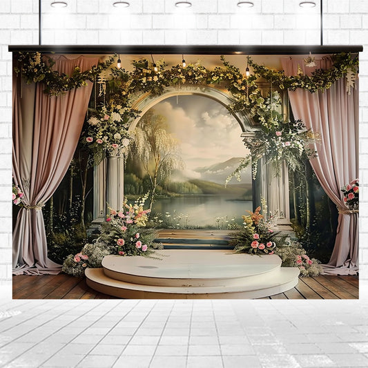 A decorated stage with vibrant flowers and an HD Vivid Floral Backdrop featuring a serene lake scene, framed by archway columns and draped in pink curtains. The Bridal Shower Photography Floral Background -ideasbackdrop by ideasbackdrop is set in an indoor space with tiled flooring, perfect for creating unforgettable memories.