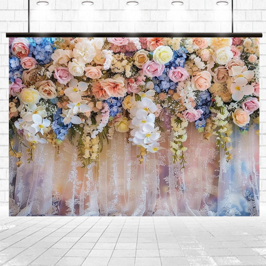 An exquisite Bridal Shower Wedding Floral Backdrop -ideasbackdrop of colorful flowers, including roses and orchids, hangs from a lace fabric in a well-lit room with a tiled floor. Perfect for weddings or any elegant event design by ideasbackdrop.