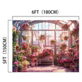 A greenhouse with potted pink flowers and plants on shelves and the floor, complemented by large windows. This 6-foot-tall, 5-foot-wide space boasts a Cherry Blossom Sunshine Flower Backdrop -ideasbackdrop that adds a stunning floral touch to every corner.
