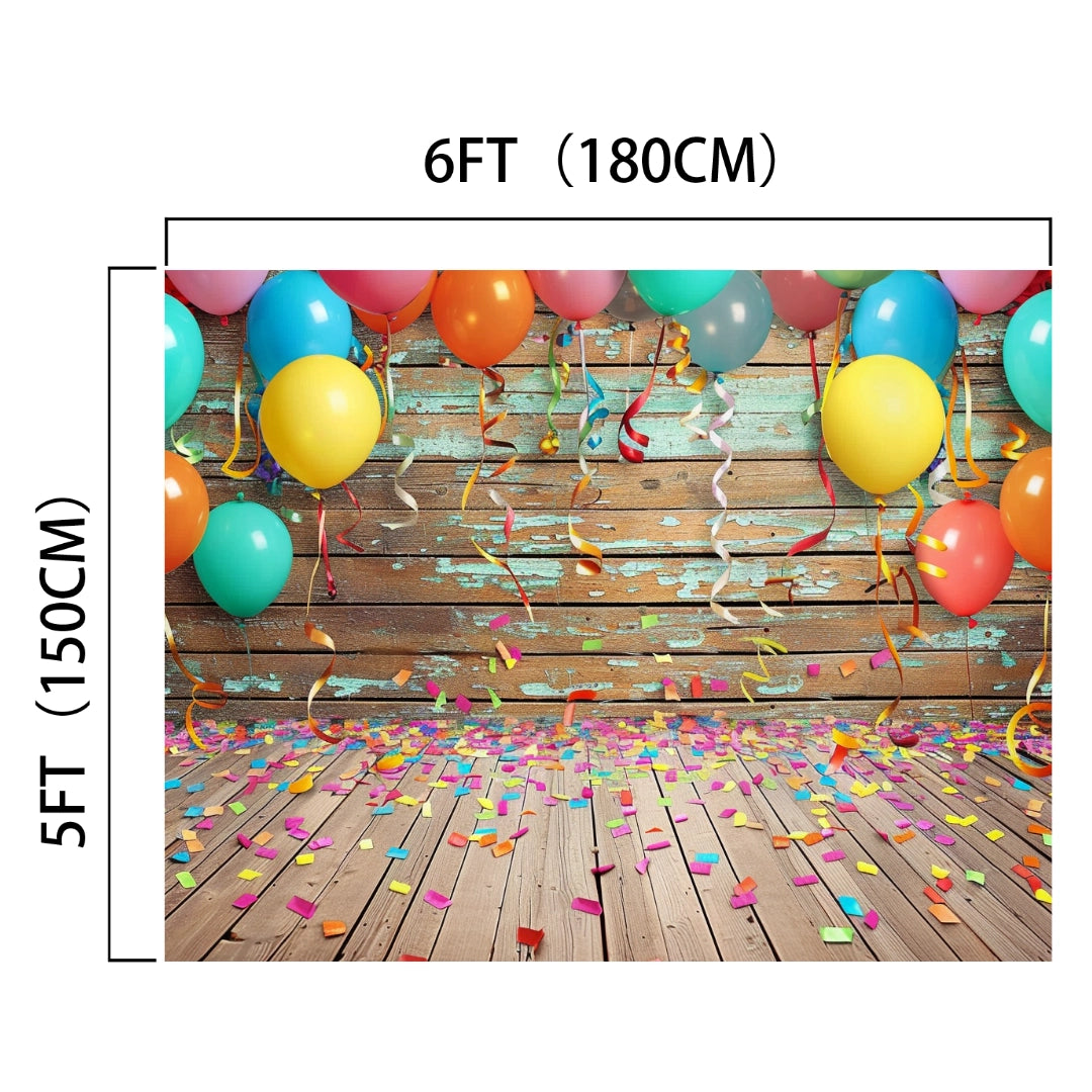A Colorful Carnival Balloons Wood Backdrop-ideasbackdrop featuring colorful balloons, streamers, and confetti on a wooden floor with realistic wood grain against a distressed turquoise wall. Dimensions noted are 6 feet (180 cm) by 5 feet (150 cm), perfect for product shoots.