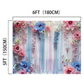 A 6-foot by 5-foot decorative backdrop featuring a blooming garden of colorful flowers and draped fabric in shades of blue, pink, and white, creating a floral fairytale ambiance is the Elegant Floral Photography Backdrop by ideasbackdrop.