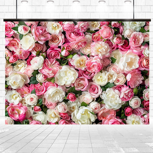 A wall covered in a dense arrangement of various pink and white roses, set against a background of white brick tiles, creating a vivid **Floral Newborn Bridal Flower Backdrop - ideasbackdrop** that enhances dreamy atmospheres by **ideasbackdrop**.