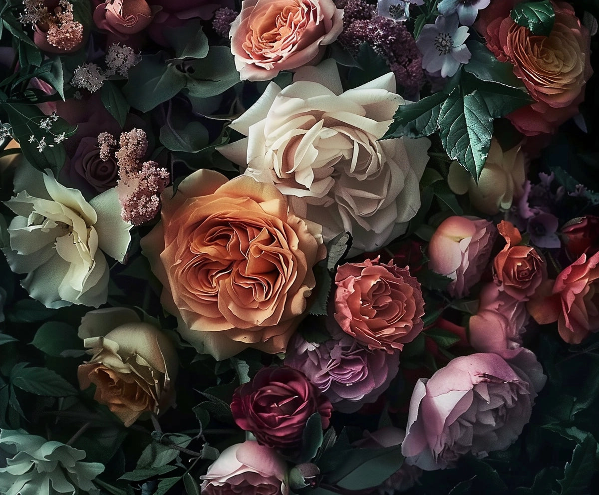 A close-up of various blooming roses in shades of pink, peach, white, and red, surrounded by green leaves and small purple flowers creates an HD vivid Floral Wallpaper Photo Props Background -ideasbackdrop bursting with botanical elegance by ideasbackdrop.