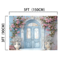 A Floral Blue Door Wall Bridal Shower Backdrop -ideasbackdrop with ornate glass panels, surrounded by pink flowers and white vases, measuring 5ft wide and 3ft tall. This charming entrance exudes botanical magnificence by ideasbackdrop.
