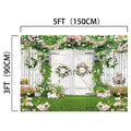 A white wooden gate adorned with flower wreaths, surrounded by lush greenery and blooming flowers. Measuring 5 feet wide and 3 feet tall (150 cm by 90 cm), it serves as the perfect Green Leaves Butterfly Spring Floral Backdrop -ideasbackdrop for any wedding ceremony decoration.