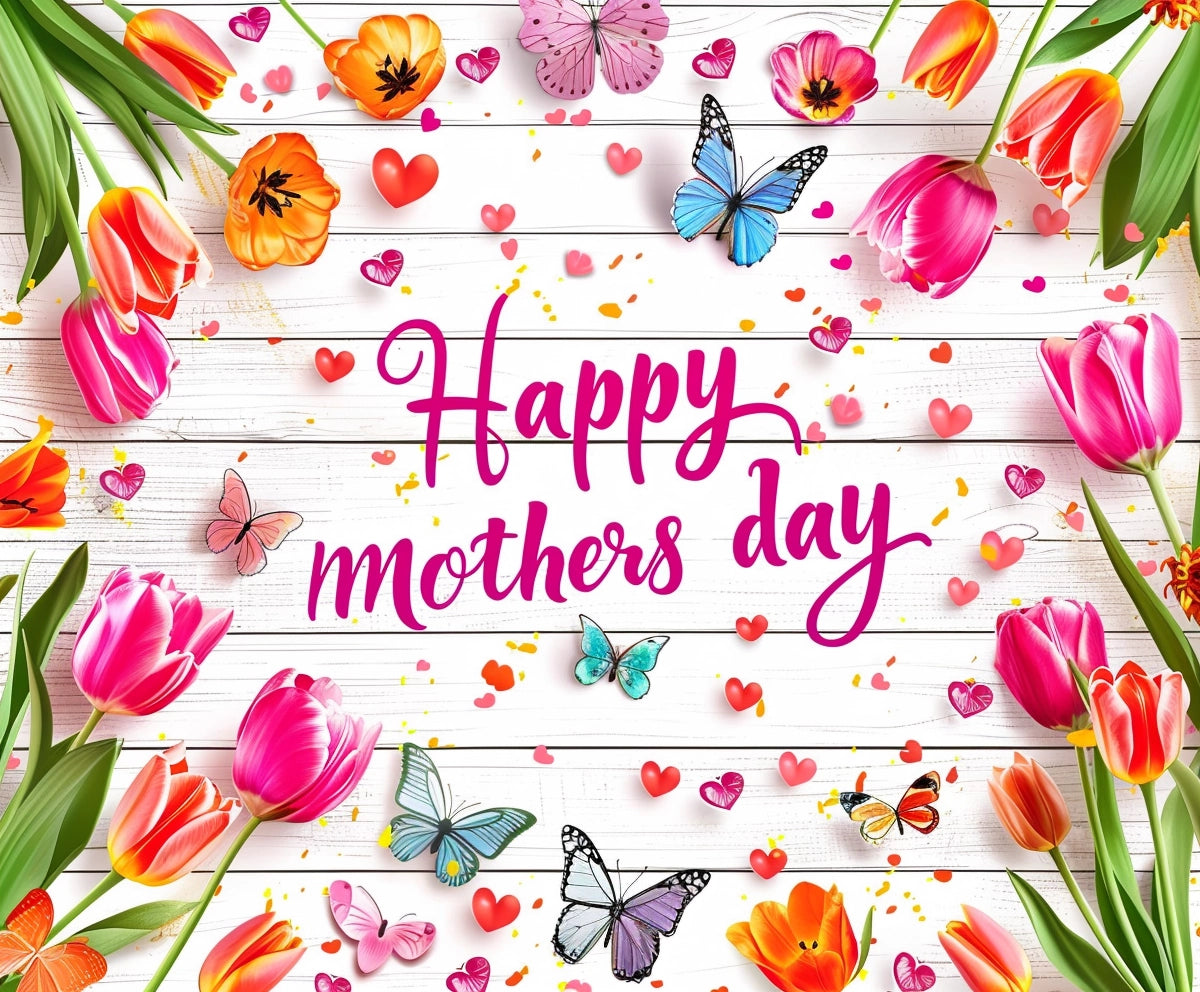 The photo showcases a "Happy Mother's Day" message in pink cursive on a white wooden backdrop, surrounded by colorful tulips, butterflies, and small hearts with the Wood Floral Happy Mother's Day Backdrop-ideasbackdrop by ideasbackdrop.