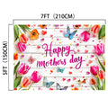 A 7ft by 5ft durable vibrant Wood Floral Happy Mother's Day Backdrop-ideasbackdrop with "Happy Mother's Day" text, adorned with pink and orange tulips, butterflies, and hearts on a white wooden background.
