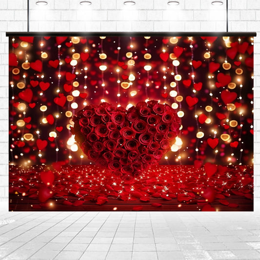 A Heart Red Rose Bridal Shower Flower Backdrop -ideasbackdrop exudes floral elegance, surrounded by hanging lights and red heart decorations against a brick wall backdrop. The lifelike botanical experience is enhanced with rose petals scattered on the ground.