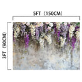 An ideasbackdrop Lavender Floral Bridal Photo Studio Backdrop with dimensions labeled as 5 feet (150 cm) wide by 3 feet (90 cm) high, featuring lifelike hanging white, purple, and pink flowers against a textured background.
