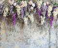 A Lavender Floral Bridal Photo Studio Backdrop - ideasbackdrop of cascading flowers in shades of purple, white, and pink against a textured wall, featuring high-definition wisteria, roses, and baby's breath by ideasbackdrop.