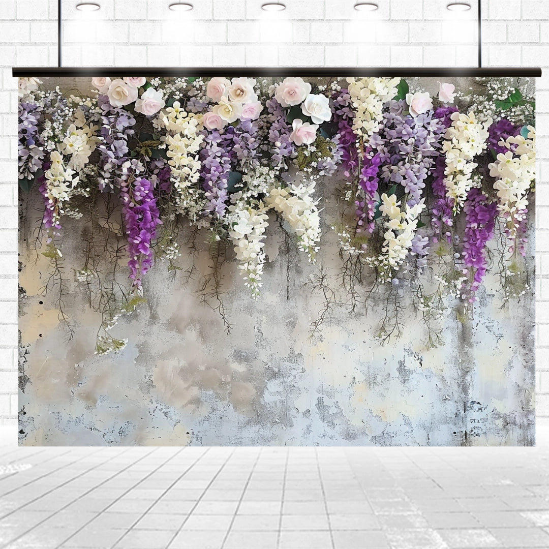 A Lavender Floral Bridal Photo Studio Backdrop - ideasbackdrop featuring an arrangement of pink, white, and purple lifelike flowers hanging against a concrete-style wall.