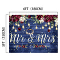 This premium quality backdrop is a 6 by 5-foot wedding decoration featuring "Mr & Mrs" text, floral arrangements, hanging lights, and a ring graphic against a blue wooden background. Capture unforgettable moments with this Mr and Mrs Flower Rustic Wedding Backdrop-ideasbackdrop by ideasbackdrop.