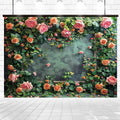 A rectangular concrete wall framed by a vibrant floral arrangement with pink and orange roses and green leaves. The background is a faded green surface, creating an Outdoor Grass Wedding Floral Backdrop -ideasbackdrop that's perfect for weddings.