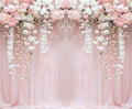 A Pink Flower Rose Blossom Wedding Backdrop-ideasbackdrop adorned with cascading pink and white flowers, enhanced by sheer pink fabric draped for a soft, romantic effect, perfect for a vibrant wedding theme.