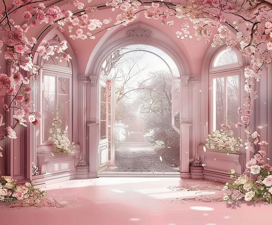 A dreamy, pastel pink room with large arched windows and doors opens to an outdoor view. The space is adorned with the Pink Flower Wedding Photography Backdrop from ideasbackdrop and cherry blossom branches and floral patterns, creating a whimsical atmosphere perfect for any event space.