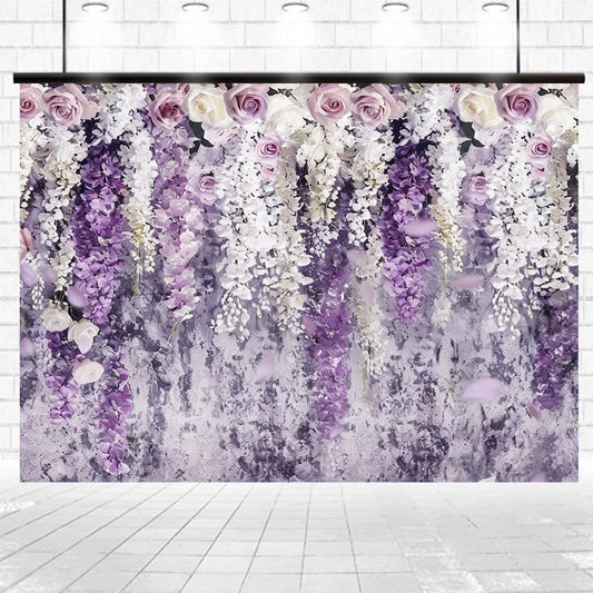 A stunning Purple Flowers Curtain Wedding Backdrop-ideasbackdrop featuring cascading purple and white flowers against a textured, grayish wall, with a light tiled floor in the foreground, adding high-definition detail to any event by ideasbackdrop.