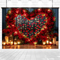 A large heart-shaped wreath made of lifelike red roses with string lights and red heart decorations. Candles and lanterns are placed below the wreath, perfect for special occasions. The Red Rose Heart Arch Photography Backdrop -ideasbackdrop from ideasbackdrop is an ideal choice.