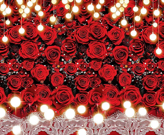 A background of densely packed red roses is adorned with hanging, glowing string lights and lace trim at the bottom, creating a Red Rose White Lace Flower Wedding Backdrop-ideasbackdrop that exudes high-definition beauty by ideasbackdrop.