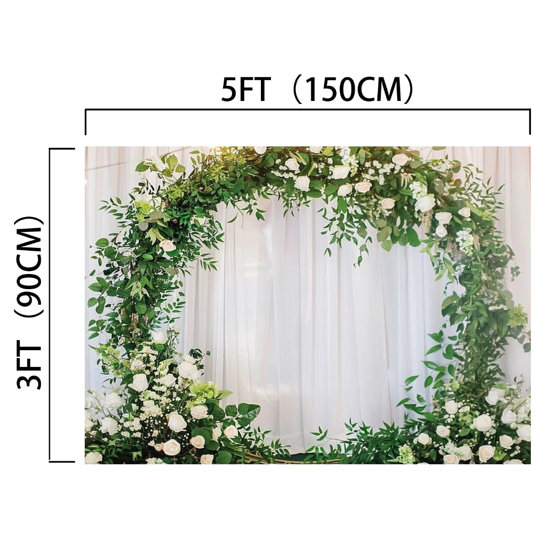 A circular floral arch measuring 5 feet (150 cm) wide and 3 feet (90 cm) high, adorned with greenery and white flowers, set against a white curtain backdrop perfect for wedding backdrops and picture-perfect moments, the Romantic Flower Wreath Bridal Wedding Backdrop-ideasbackdrop from ideasbackdrop.