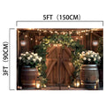 Wooden barn doors adorned with lifelike white flowers and greenery, flanked by barrels, under string lights. The Rustic Western Barn Door Floral Backdrop -ideasbackdrop dimensions are labeled: 5ft (150cm) wide and 3ft (90cm) tall.