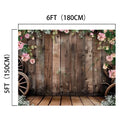 Rustic Wood Barn Wall Leaves Flower Backdrop - ideasbackdrop measuring 6 feet by 5 feet, featuring a rustic wooden plank design with high definition flowers, pink blooms, and wagon wheels.
