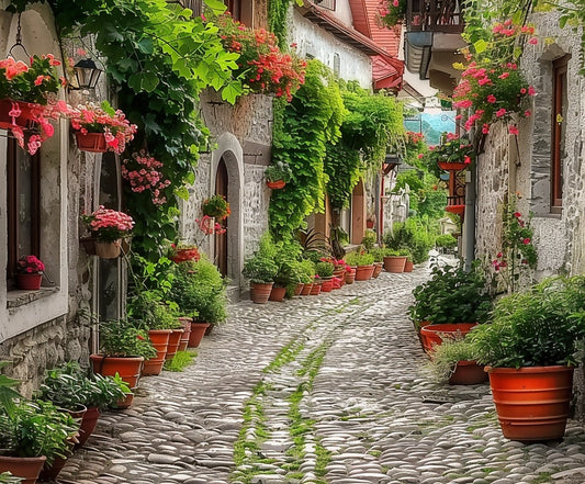 A narrow, cobblestone street lined with the **Spring Alleyway Potted Flowers Backdrop -ideasbackdrop** on both sides, leading towards houses with green ivy and blooming flowers hanging from balconies creates a perfect floral paradise.