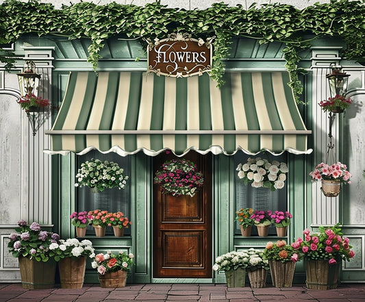 A flower shop with a green and white striped awning, a wooden door adorned with the Spring Flowers Store Wood Door Backdrop-ideasbackdrop by ideasbackdrop, and various potted plants and flowers in vivid colors displayed at the entrance.