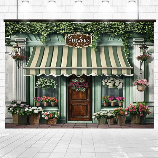 A flower shop with a striped green and white awning, vivid colors from the plants on the windowsills, and various potted flowers displayed outside. The shop, featuring a Spring Flowers Store Wood Door Backdrop-ideasbackdrop, has a sign labeled "Flowers" above the entrance.