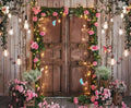 A rustic wooden double door adorned with strings of lights, pink roses, greenery, and butterflies. The Spring Photography Backdrop Wooden Barn Door -ideasbackdrop by ideasbackdrop completes the scene with surrounding potted flowers and hanging light bulbs, creating a whimsical garden atmosphere—perfect for event planners seeking ultra-realistic floral designs.