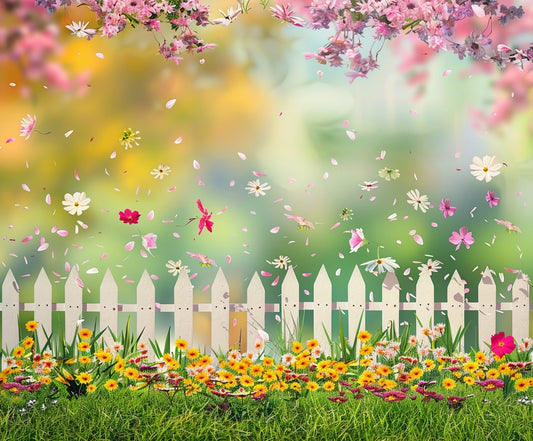 A white picket fence stands amidst a vibrant garden with yellow, pink, and white flowers. Pink blossoms and petals fall gracefully against a blurred green and yellow background, creating the perfect Spring Flowers Kids Birthday Pink Floral Backdrop - ideasbackdrop by ideasbackdrop for online meetings.