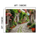 A cobblestone street in a village is bordered by stone buildings and lush greenery, with potted plants lining the path. The lifelike detail creates an HD vivid flower backdrop, turning the scene into a floral paradise. The dimensions of this picturesque setting are 6 feet by 5 feet (180 cm by 150 cm). The product used is the Spring Alleyway Potted Flowers Backdrop -ideasbackdrop by ideasbackdrop.