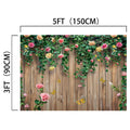 A wooden fence adorned with climbing plants and HD flowers in shades of pink, with butterflies gracefully flying around. This captivating Spring Floral Wood Plank Photoshoot Flowers Backdrop -ideasbackdrop, perfect for event decorators, measures 5 feet by 3 feet (150 cm by 90 cm).