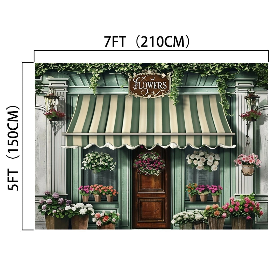 A storefront with a striped awning and a sign that reads "Flowers," surrounded by various potted plants and flowers, boasts vivid colors and an ideasbackdrop Spring Flowers Store Wood Door Backdrop-ideasbackdrop, measuring 7 feet (210 cm) wide and 5 feet (150 cm) tall.