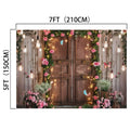 A floral-themed wooden double door decoration with HD Vivid Floral Backdrop featuring hanging lights, pink roses, butterflies, and white flowers. This elegant backdrop measures 7 feet (210 cm) wide by 5 feet (150 cm) high. The Spring Photography Backdrop Wooden Barn Door - ideasbackdrop from ideasbackdrop is perfect for adding a touch of elegance to any setting.