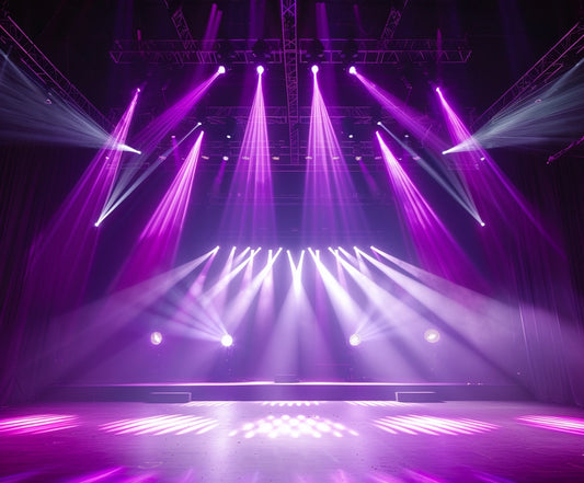 A stage with black curtains and multiple bright spotlights in purple hues illuminating the area, complemented by a vibrant theater backdrop from the ideasbackdrop Stage Spotlight for Photography Backdrop Live Show Theater Background Rock Concerts Music Club Banner Birthday Portrait Studio Props 7x5ft.