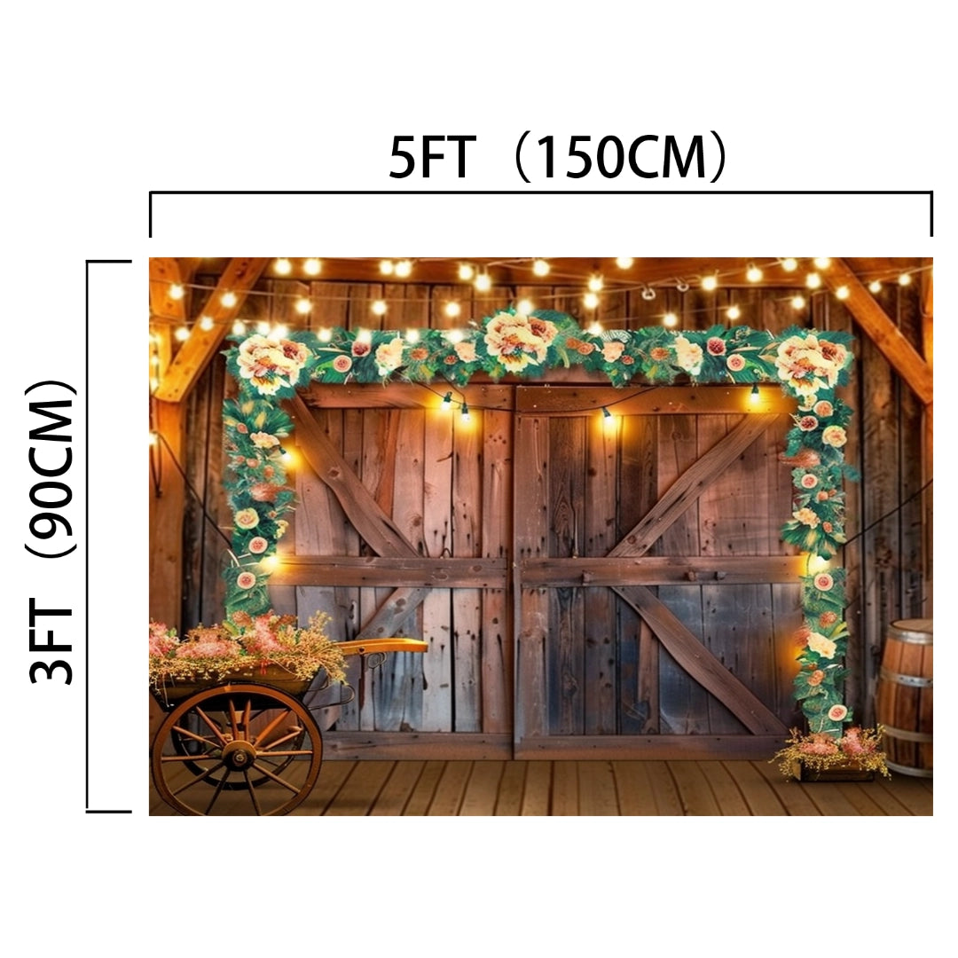 Western Cowboy Floral Wood Barn Barn Backdrop-ideasbackdrop, embodying rustic elegance, is decorated with string lights and a floral garland. Measuring 5 feet in width and 3 feet in height, it captures the essence of a countryside barn. A wooden cart with flowers sits nearby, and ideasbackdrop's rustic decor surrounds the backdrop.
