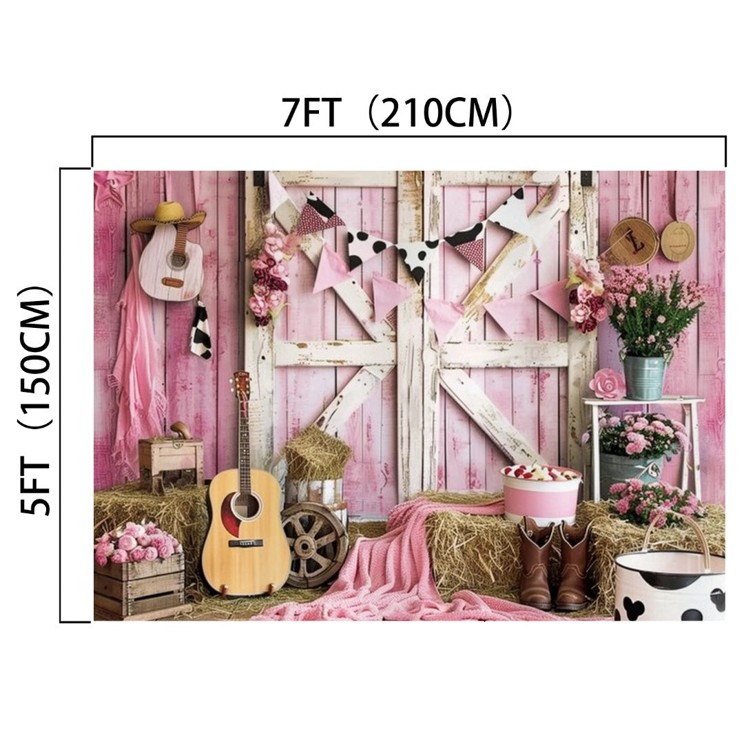 A Western Cowgirl Wild West Rustic Barn Backdrop-ideasbackdrop in pink with a guitar, hay bales, flowers, and cow-print decorations. Perfect for bringing that countryside vibe to your event. Dimensions: 7ft (210cm) in width and 5ft (150cm) in height. Brand Name: ideasbackdrop