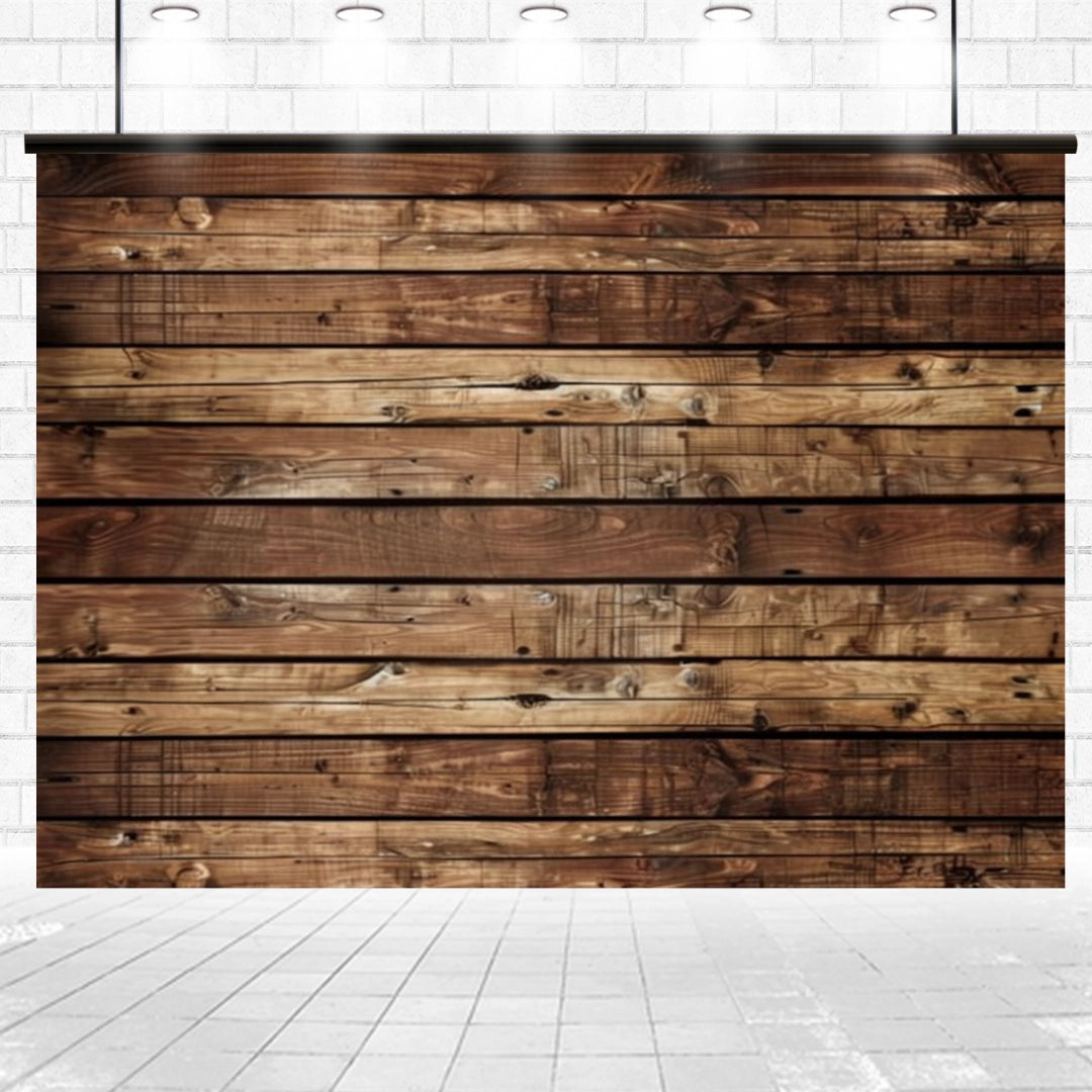 A wooden wall with horizontal planks in various shades of brown, creating a Wooden Boards Photography Wood Backdrop-ideasbackdrop by ideasbackdrop, is positioned against a white brick wall. The floor is tiled in white, and five lights hang from the ceiling above, adding a touch of vintage flair.